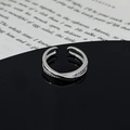 Macro shot of silver adjustable cross ring with pavé zircons on black mirror base - Double Layer Cross Pave Minimalist Style (JZ4843B)