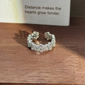 Detailed macro view of an adjustable silver flower ring set with shimmering zircons - Hollow Flower Snowflake Style (JZ2823) / Silver