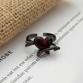 Close-up of gothic dark metal ring with red heart stone and arrow design details - Arrow Through Heart Style (JZ5532A)