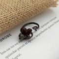Macro shot of gothic black snake ring with red heart gem and embossed rose detail - Red Heart Purple Heart Rose Style (JZ5863A)