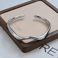 Minimalist silver wavy open bangle bracelet with a high-polished metallic finish - Wavy Style / Silver