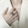 Vintage silver crown ring featuring a bright purple heart gemstone on model index finger - Purple