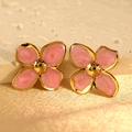 Macro view of pink marble enamel four-petal flower earrings with a golden metal finish - Pink