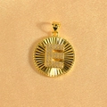 Macro detail of gold-plated sunburst pendant with crystal-encrusted letter E - Letter E / Gold