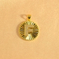 Detailed macro view of gold-plated sunburst pendant with crystal-studded letter F - Letter F / Gold