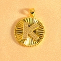 Macro shot of gold plated sunburst pendant featuring letter K set with sparkling zircons - Letter K / Gold