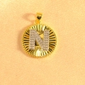 Macro shot of gold sunburst pendant with crystal-encrusted silver letter N detail - Letter N / Two Colors