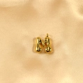 Polished gold bubble letter M pendant with a mirror finish on elegant silk background - Letter M / Gold