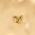 Polished gold bubble letter V pendant with a glossy finish on champagne silk fabric - Letter V / Gold