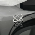 Macro shot of silver crisscross ring with white zircons on black mirror surface - Adjustable Open / Cross Design Style (JZ0310)