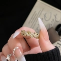Macro detail of gold oval zircon ring with micro-pave wave lines on finger - Yellow Gemstone Wave Gold Band (JZ4667)