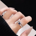 Detailed view of an aquamarine blue stone ring with layered band on a model's hand - Double Layer Irregular Style (JZ4741)