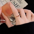 Close-up of vintage gold twist ring with a red enamel bow detail on a hand - Bow Knot Twist Style (JZ4226) / Open Adjustable