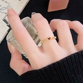 Close-up of a vintage hollow gold ring with a red heart on a model holding perfume - Heart Hollow Style (JZ4201) / Open Adjustable