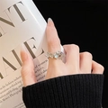 Detailed close-up of a silver open ring with floral engraving and a blue moonstone gem - Adjustable Open / Floral Leaf Light Blue Stone Style (JZ4871) / Silver