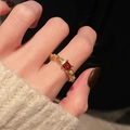 Macro detail of a vintage gold ring with square red gemstone and pavé diamond accents - Square Ruby Style (JZ5457)