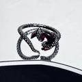 Macro shot of dark gothic snake ring with red gemstone on reflective mirror - Snake Scale Dark Ruby Style (JZ5628)