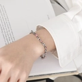 Silver pig nose chain bracelet with pink round zircon inlay on a model's wrist - SL0071 Style (SL0071) / Steel + Pink Zircon