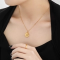 24K gold plated Sagittarius zodiac coin necklace and minimalist ring on model - Sagittarius / Gold