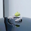 Detailed macro view of silver green enamel rose ring with zircon accents and reflection - Adjustable Open / Green Rose Bud Style (JZ1876A)