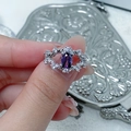 Close-up of a silver vine ring with an oval purple gemstone and leaf-shaped zircons - Vine Leaf Style (JZ3913A)