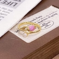 Detail of a gold tulip ring with pink enamel and a white pearl in a warm vintage setting - Adjustable Open / Pink Tulip Style (JZ4352)