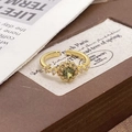 Close-up of vintage gold ring featuring olive green zircon and floral halo detail - Adjustable Open / Olive Green Sunflower Style (JZ4729)