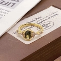 Detail shot of vintage gold ring with olive green stone and zircon accents - Adjustable Open / Olive Green Oval Stone Style (JZ5285)