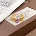 Detail view of gold feather ring with purple teardrop gemstone and sparkling zirconias - Adjustable Open / Purple Teardrop Feather Texture Style (JZ5718)