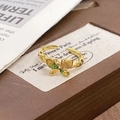 Detailed close-up of a golden butterfly ring with green enamel wings and adjustable open band - Adjustable Open / Bright Gold Green Butterfly Style (JZ5731)