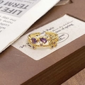Detail of adjustable gold ring with purple heart and pear stones on vintage wood - Adjustable Open / Purple Stone Vintage Leaf Style (JZ5764)