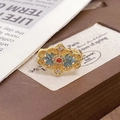 Retro hollow flower ring with blue enamel leaves and a red bead on a gold finish - Adjustable Open / Vintage Hollow Court Floral Style (JZ5843)