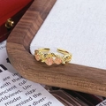 Vue détaillée de trois roses en émail rose sur une bague dorée au style vintage - Style Triple Rose Émail Rose (JZ6097)