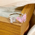 Macro detail of silver adjustable ring featuring pink butterfly and zircon flower accents - Asymmetric Butterfly Flower Style (JZ3837)