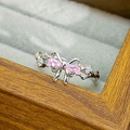 Macro shot of silver bow ring with pink pear-shaped stones and white zircon details - Bowknot Style (JZ4366)
