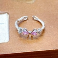 Detailed close-up of adjustable silver twist ring with pink zircon butterfly element - Twisted Rope Bowknot Style (JZ4366)