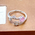 Macro shot of silver adjustable ring with pink square zircon and hollow star detail - Square Pink Zircon And Star Intertwined Style (JZ4881)