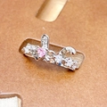 Detail of pink heart zircon ring with butterfly motif and pavé stones on a display card - Pink Heart And Rabbit Ear Style (JZ6164)