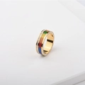 Detail of gold titanium ring with colorful enamel inlay and sparkling zircon border - US 6 / Gold