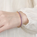 Elegant gold tennis bracelet for women featuring round cut purple zircon stones in a row - Purple Zirconia