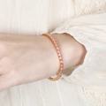 Elegant gold tennis bracelet with square pink zircons on a delicate feminine wrist - Pink Zircon
