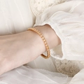 Champagne zircon tennis bracelet in gold finish worn over a white lace sleeve - Champagne Zircon Style