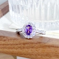 Macro view of purple oval gemstone ring with halo diamond setting and silver band - Oval Halo Design (JZ3095A)