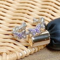 Macro shot of silver ring featuring purple zircon butterfly cluster and pavé setting - Purple Zircon Continuous Butterfly Style (JZ4578)