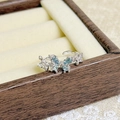 Macro shot of silver butterfly ring with blue pear-cut gems and micro-pave details - Light Blue Butterfly Style (JZ0272A)