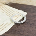 Detail of silver twisted rope ring featuring a textured braided finish and open band design - Twisted Rope Style (JZ2246)