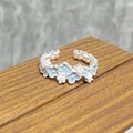 Close-up of adjustable silver ring with light blue enamel flowers and zircon accents - Blue Flower Ball Style (JZ0089A)