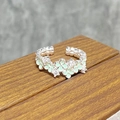 Macro detail of silver open ring featuring green enamel flowers and sparkling zircons - Green Flower Bead Dot Style (JZ2237A)