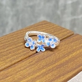 Detail of S925 silver ring with blue enamel flowers and tiny cubic zirconia inlay - Blue Floral Twist Style (JZ2462A)