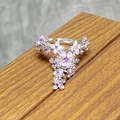 Detailed close-up of fan-shaped flower ring with purple gemstones on wooden stand - Purple Fan Shaped Flower Style (JZ3072A)